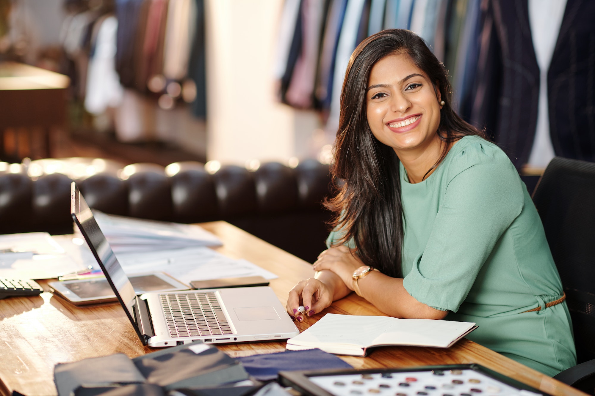 Happy young Indian atelier owner